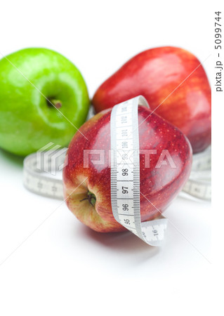apple and measure tape isolated on white apple and measure tape isolated on white 5099744