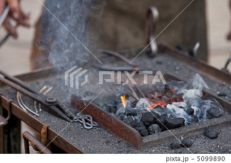 embers, fire, smoke, tools and the hands of a blacksmith embers, fire, smoke, tools and the hands of a blacksmith 5099890