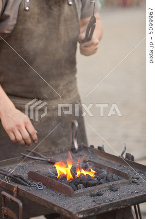 embers, fire, smoke, tools and the hands of a blacksmith embers, fire, smoke, tools and the hands of a blacksmith 5099967