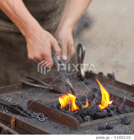 embers, fire, smoke, tools and the hands of a blacksmith embers, fire, smoke, tools and the hands of a blacksmith 5100210
