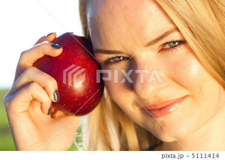 portrait of a beautiful young woman with apple outdoor portrait of a beautiful young woman with apple outdoor 5111414