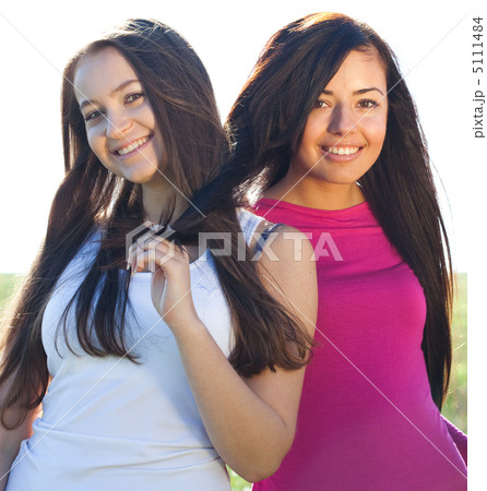 portret of two young beautiful woman on the  sky background 5111484