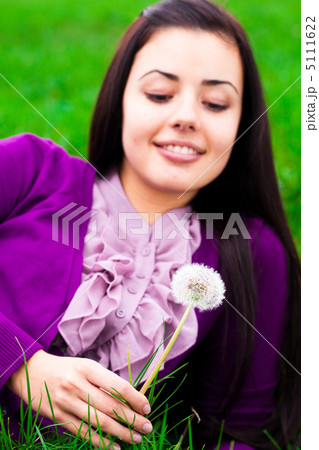 portrait of a beautiful young woman with dandelion portrait of a beautiful young woman with dandelion 5111622