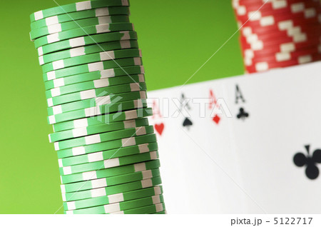 Casino chips and four aces against green background 5122717