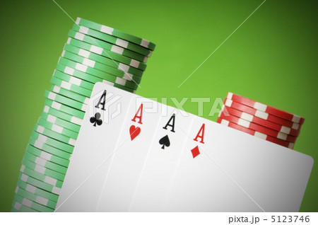 Casino chips and four aces against green background Casino chips and four aces against green background 5123746