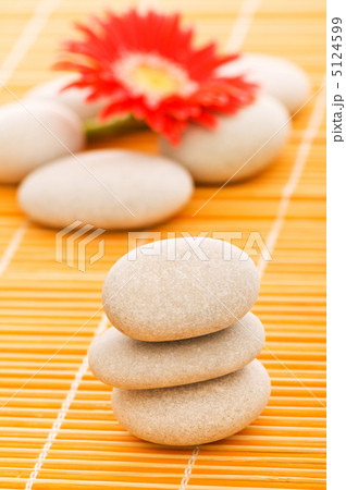 Red flower and stack of spa pebbles 5124599