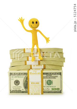 Smilie sitting on top of dollar stack Smilie sitting on top of dollar stack 5124754