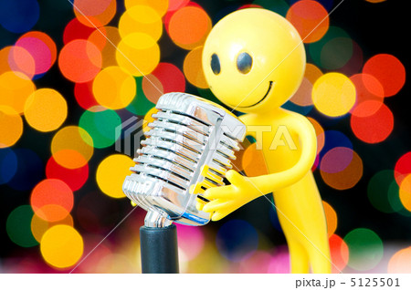 Vintage microphone and smilie against blurred lights 5125501