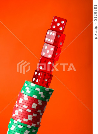 Casino chips and cards against red background 5129581