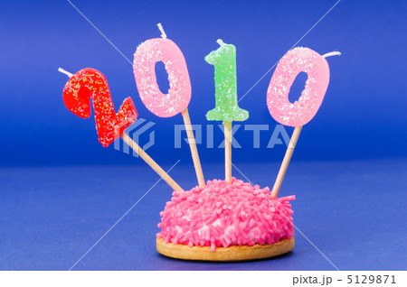 Candles with 2010 year against colourful background Candles with 2010 year against colourful background 5129871
