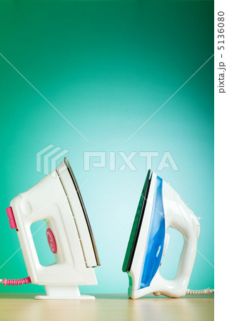 Modern electric iron against the colorful background 5136080