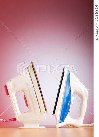 Modern electric iron against the colorful background 5136814