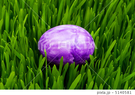 Easter concept - colourful eggs in green glass 5140581