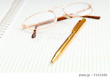 Pen and eye glasses on the page 5141880