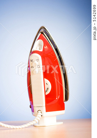 Modern electric iron against the colorful background 5142699