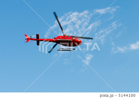 Red helicopter on the bright summer day 5144100