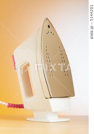 Modern electric iron against the colorful background Modern electric iron against the colorful background 5144201