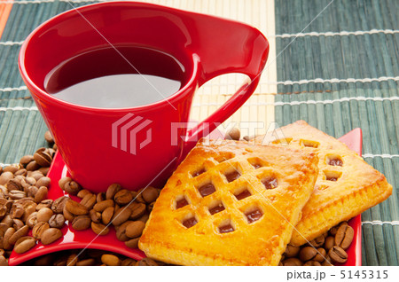 Cup of coffee with many beans around 5145315