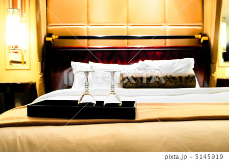 Two glasses on the double bed as romantic concept Two glasses on the double bed as romantic concept 5145919