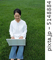 芝生の上でＰＣを楽しむシニア女性　縦 5148884