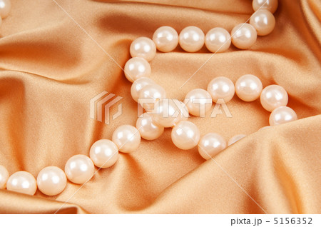Pearl necklace on the bright satin background 5156352