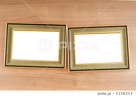 Picture frames on the polished wooden background 5156353