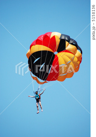 Multi coloured parachute over the blue sky Multi coloured parachute over the blue sky 5158136