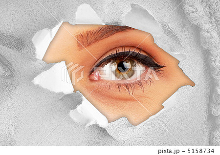 Woman eye through hole in paper Woman eye through hole in paper 5158734