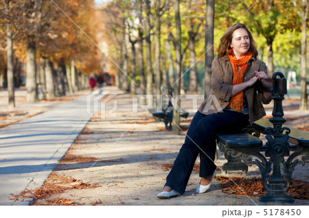 Beautiful girl sitting at the bench in Paris by fall 5178450