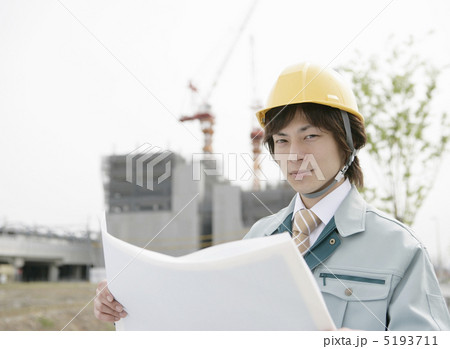 建設現場で設計図を広げるビジネスマン 5193711