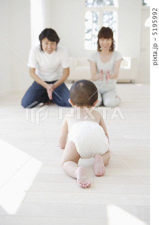 両親の元へはいはいしていく赤ちゃん 5195992