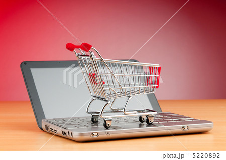 Internet online shopping concept with computer and cart 5220892