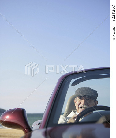 帽子をかぶりオープンカーに乗る日本人のシニア男性の写真素材 523