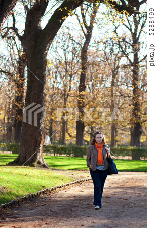 Beautiful young woman enjoying warm autumn day in park Beautiful young woman enjoying warm autumn day in park 5233499