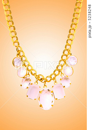 Golden jewellery against gradient background 5238248