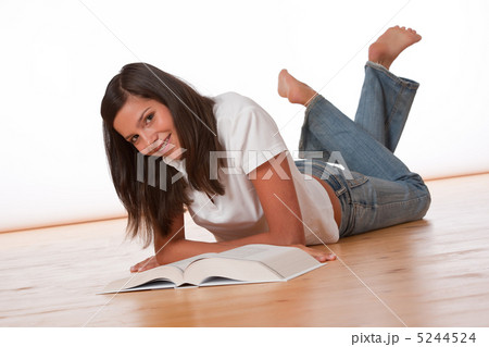 Happy teenager lying down with book 5244524