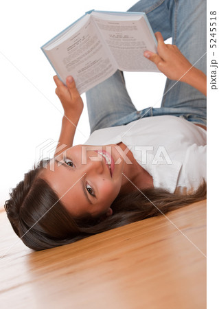 Brown hair teenager lying down on wooden floor 5245518