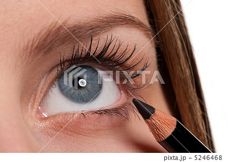 Blue eye, woman applying black make-up pencil 5246468