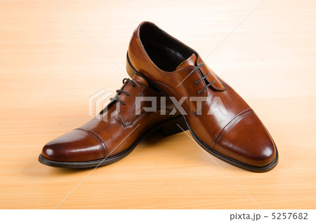 Brown shoes on wooden table Brown shoes on wooden table 5257682