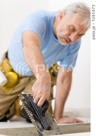 Home improvement, renovation - handyman laying tile 5265873