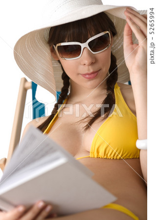 Beach - Young woman in bikini sunbath with book Beach - Young woman in bikini sunbath with book 5265994