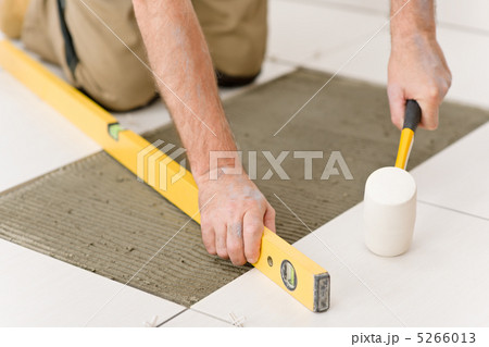 Home improvement, renovation - handyman laying tile 5266013