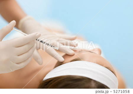 Botox injection - Woman in cosmetic medicine treatment Botox injection - Woman in cosmetic medicine treatment 5271058