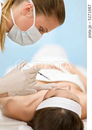 Botox injection - woman in cosmetic medicine treatment Botox injection - woman in cosmetic medicine treatment 5271067