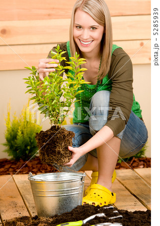 Gardening woman planting on terrace 5285939