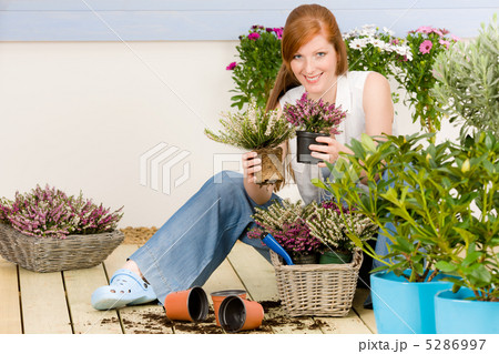 Summer garden terrace redhead woman hold flower 5286997