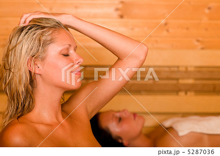 Sauna two women relaxing sweating covered towel 5287036