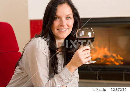 Winter home fireplace woman glass red wine 5287232