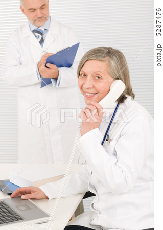 Medical team senior female phone male colleague Medical team senior female phone male colleague 5287476