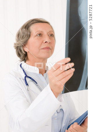 Senior doctor female looking at x-ray 5287721